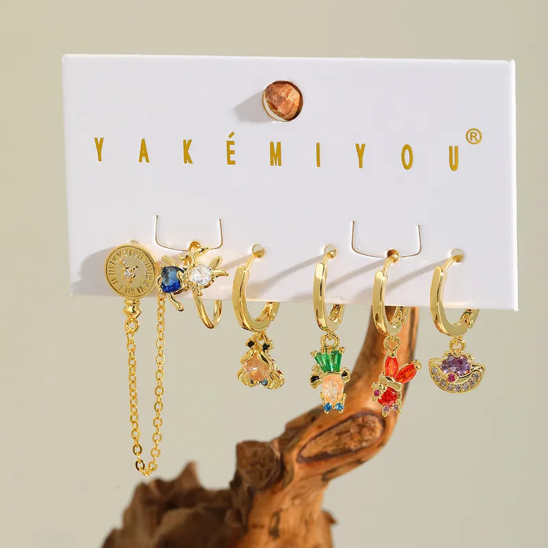 Set de 6 aretes Alicia en el País de las Maravillas baño de oro 14k